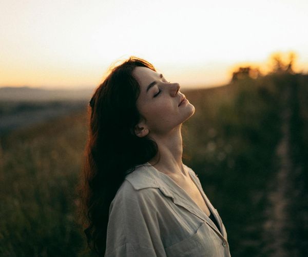 Woman feeling energetic and balanced in a nature setting.
